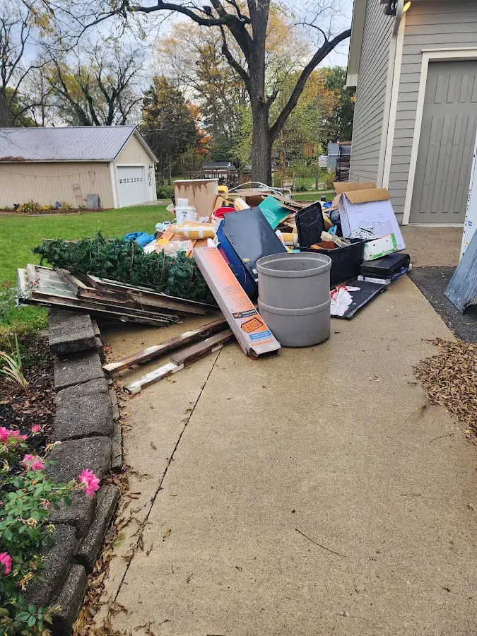Dumpster being loaded with debris for Estate Cleanout Dumpster Rental in Bellevue